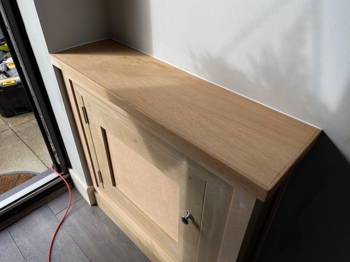 Fusebox cabinet inside front door with oak top